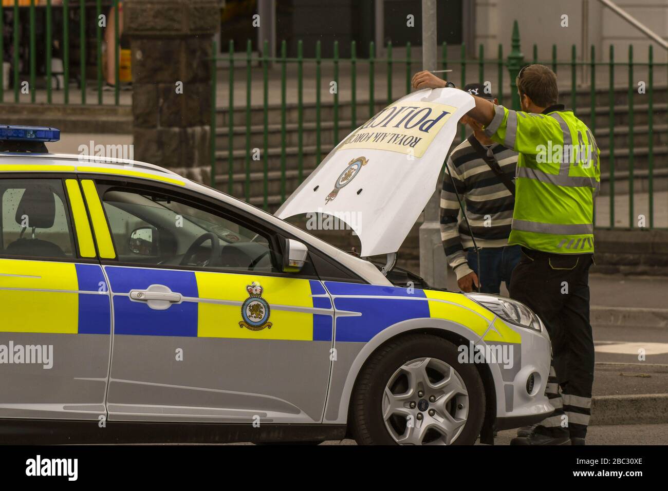 SWANSEA, WALES - JULI 2018: Mechaniker der AA besucht einen zerbrochenen Polizeipatrouillenwagen der RAF in Swansea, Wales. Stockfoto