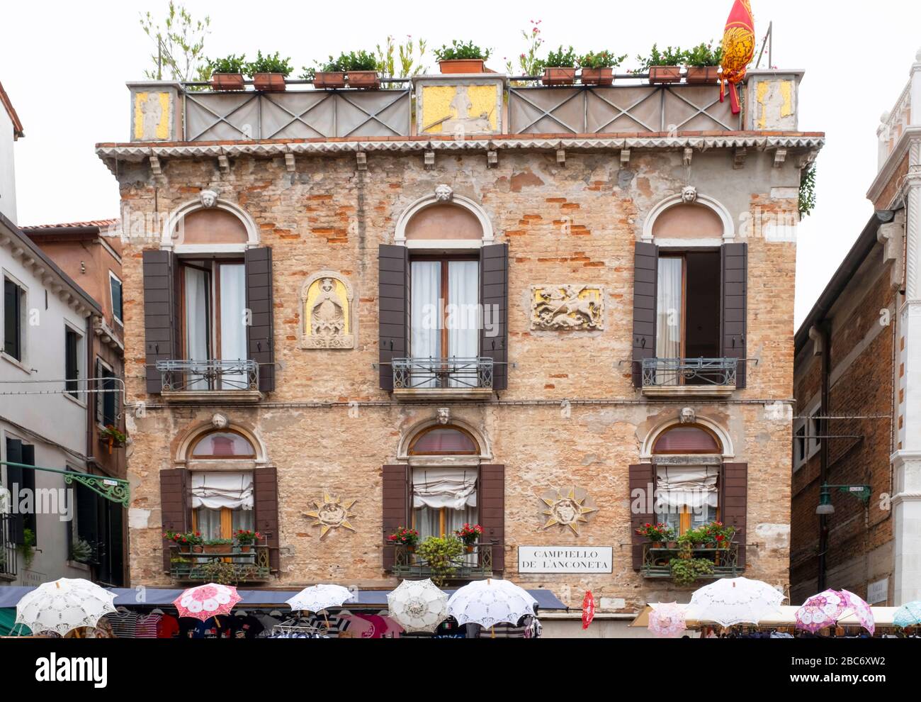 Venedig, Italien - 30. Juni 2017: Blick auf ein farbenfrohes venetianisches Haus mit Sonnenschirmen im Vorland von Venedig, Italien. Stockfoto