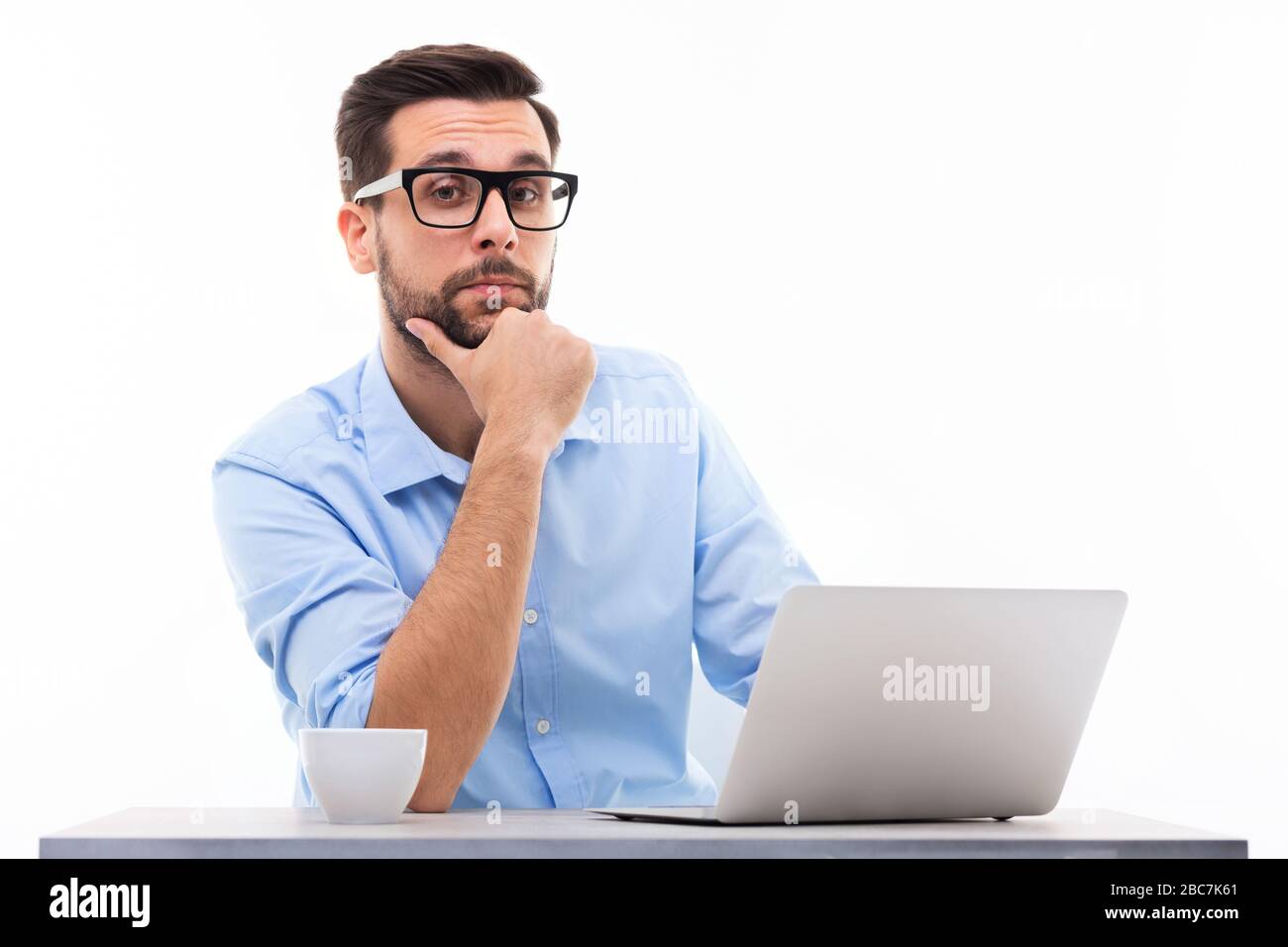 Mann an Schreibtisch mit Laptop Stockfoto