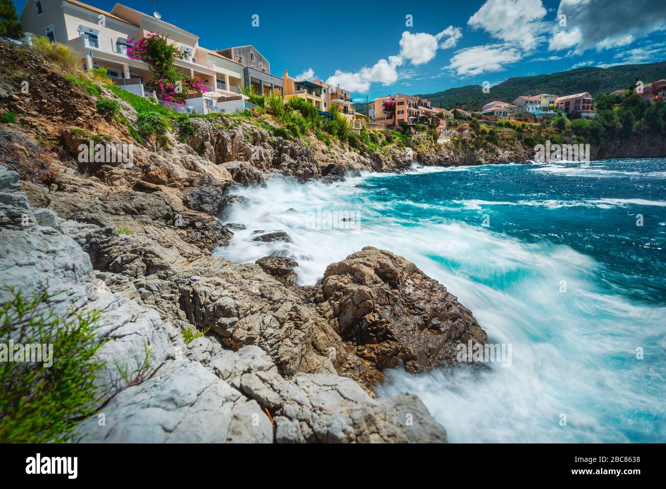 Lange Zeit mit dem malerischen dorf mediterranean Assos, Insel Kefalonia Griechenland. Bunte Häuser am felsigen Ufer. Sommerurlaub. Stockfoto