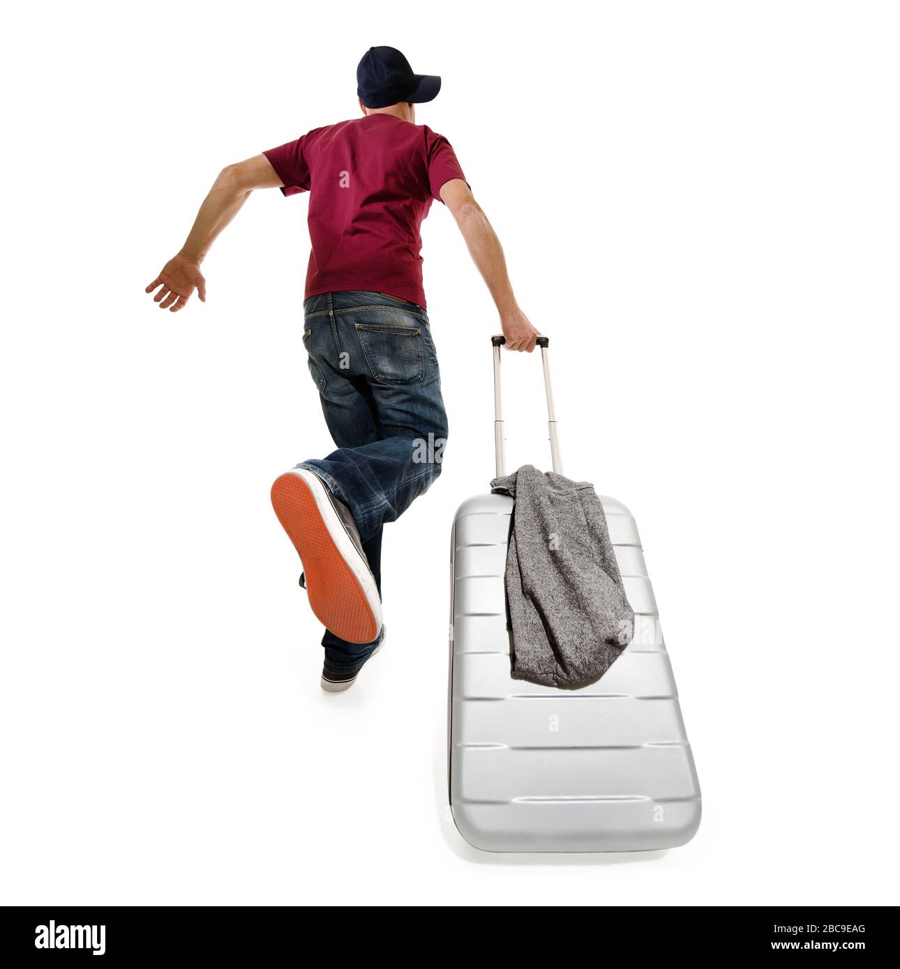 Passagier, der zum Abflug am Abflug fliegt, wird mit einem Koffer beeilt Stockfoto