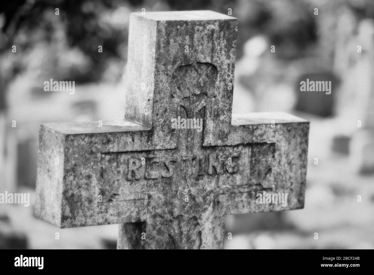 Ein Schwarz-Weiß-Foto eines christlichen Kreuzgrabsteins auf einem Friedhof, Großbritannien Stockfoto