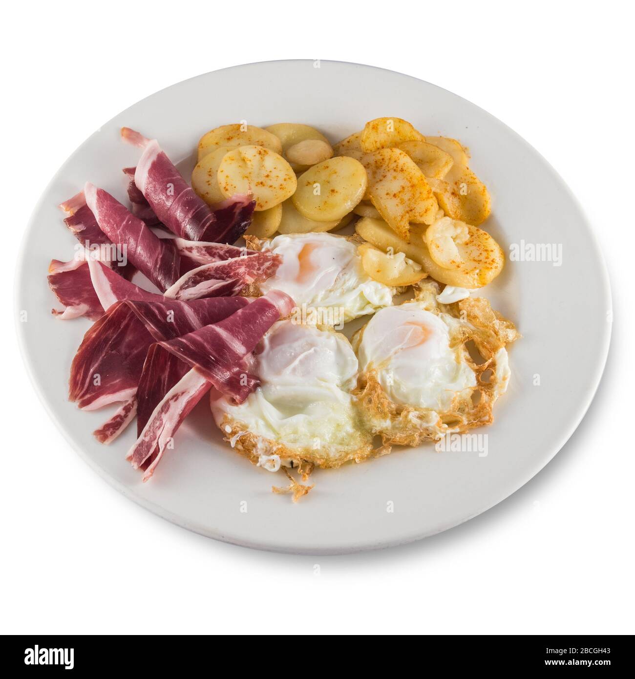 Teller mit zerbrochenen Eiern mit Schinken und Kartoffeln. Stockfoto