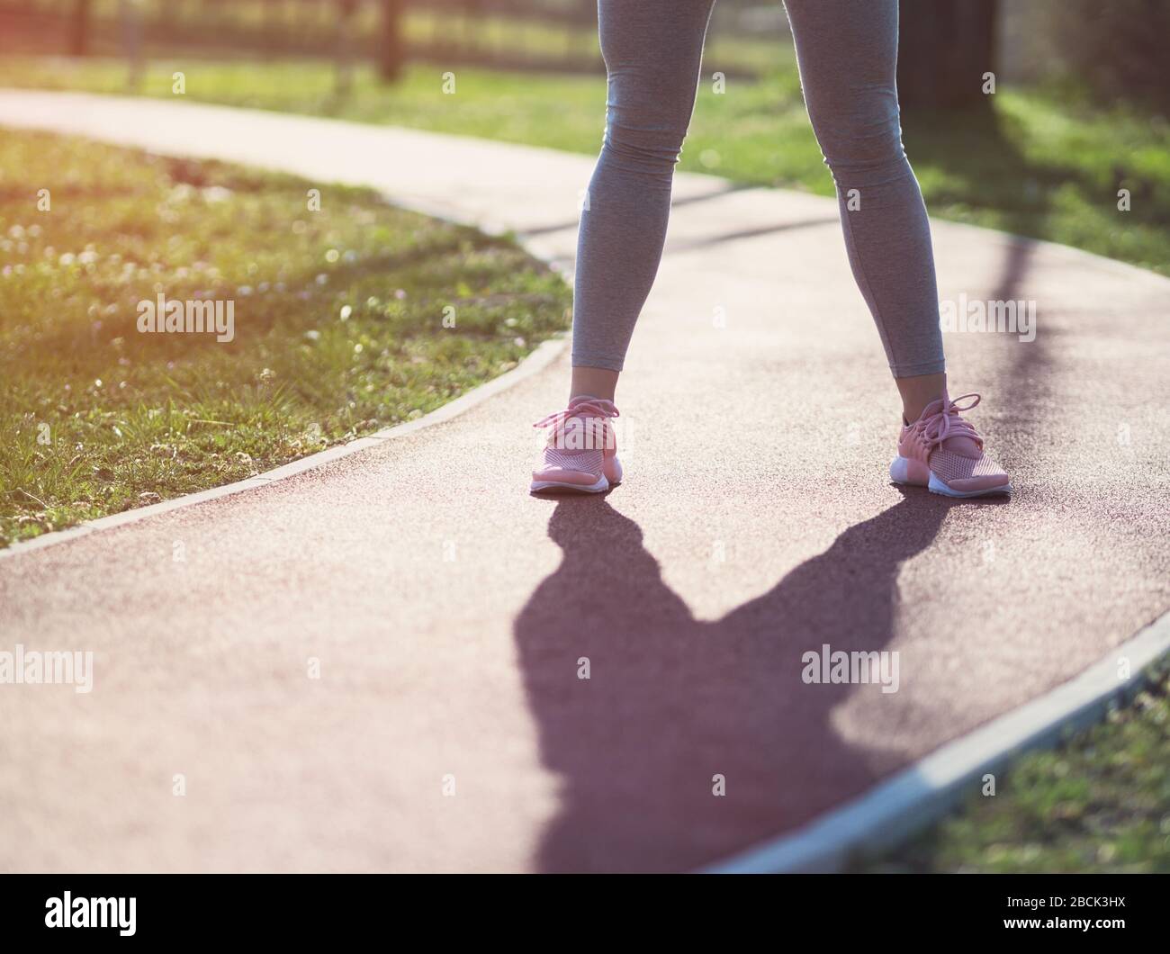 Frau steht auf Laufstrecke im Park Closeup Stockfoto