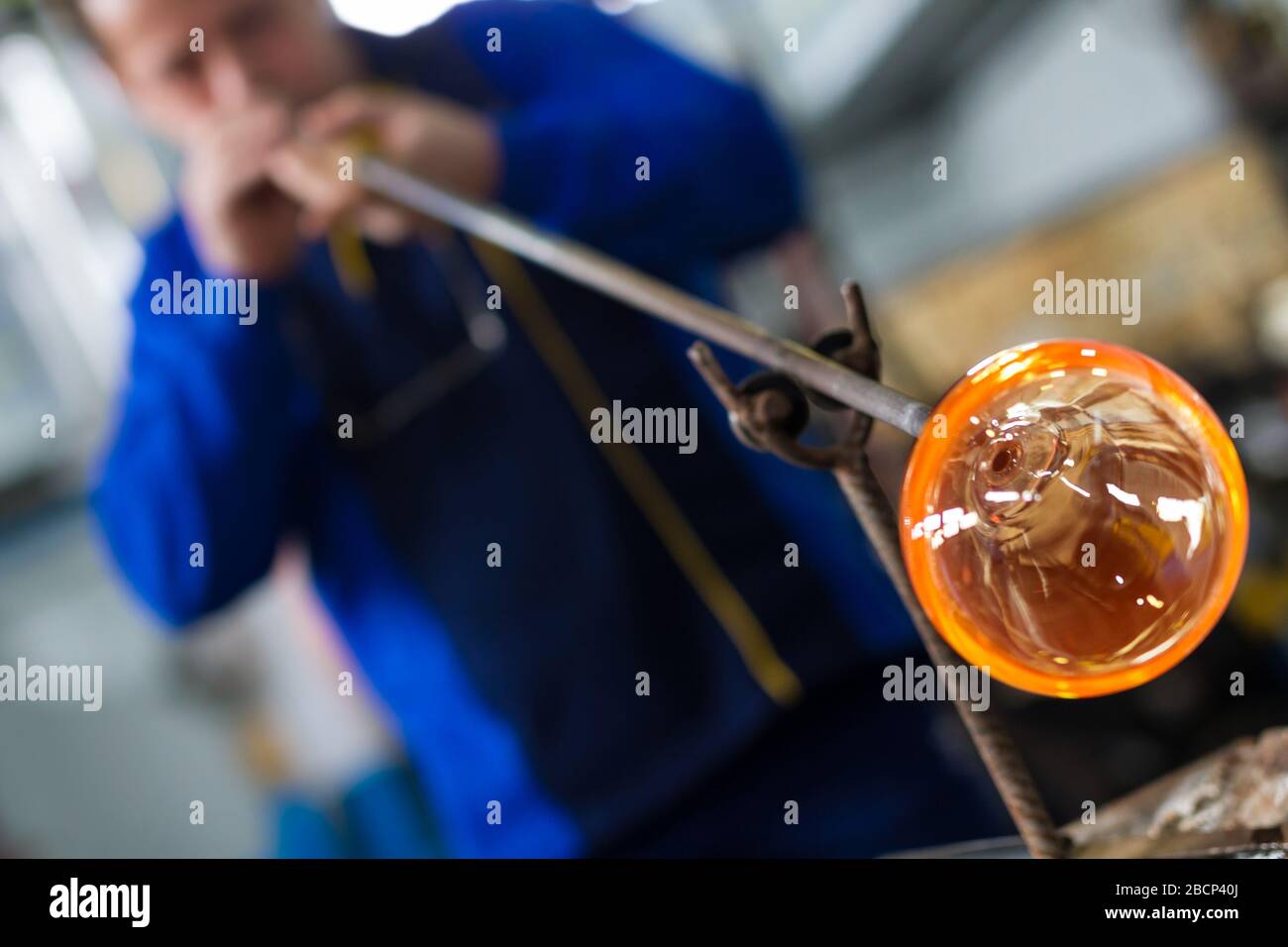 Beloslav/Bulgarien - 5. Mai 2019: Glasbläser bilden ein wunderschönes Stück Glas. Ein Glaskrafter brennt und weht ein Kunststück. Stockfoto