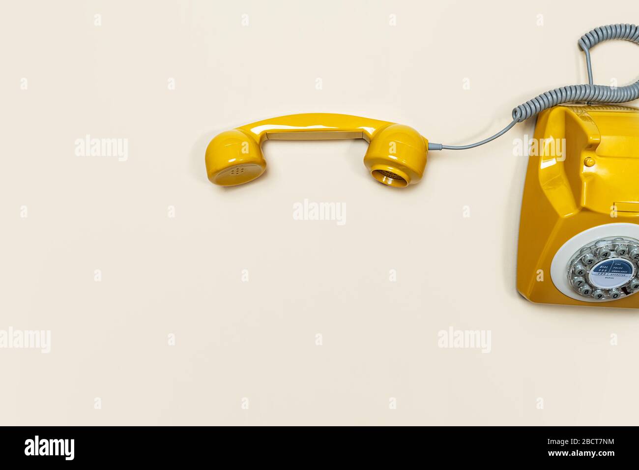 Altmodisches Mobilteil auf beigefarbenem Hintergrund. Modernes Rotationstelefon im Retro-Stil. Neue alte Technologie. Stockfoto