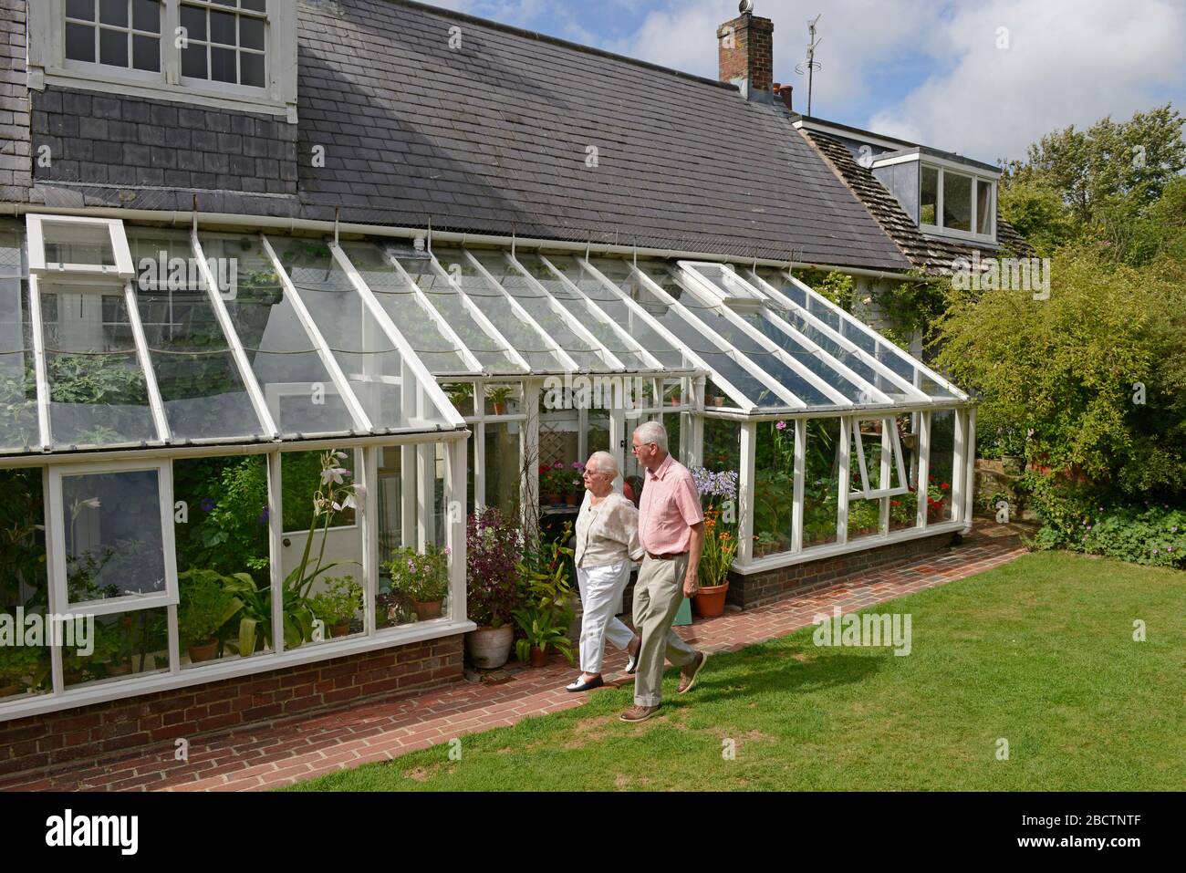 Blick auf Monk's House, einst das Zuhause von Virginia Woolf, Rodmell, East Sussex, Großbritannien, aus dem Garten, mit prominenten Holz-und Glas-Wintergarten. Stockfoto