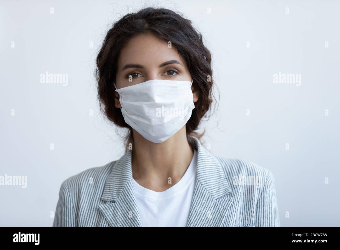 Porträt der jungen schönen Frau, die eine Atemschutzmaske trägt. Stockfoto