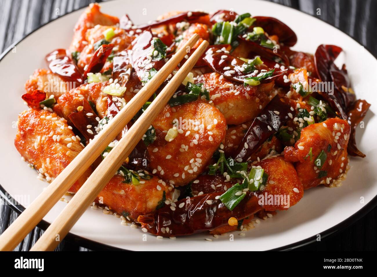 Sehr würziges Sichuan-Mala-Huhn ist ein beliebtes Gericht in China in der Nähe eines Tellers auf dem Tisch. Horizontal Stockfoto