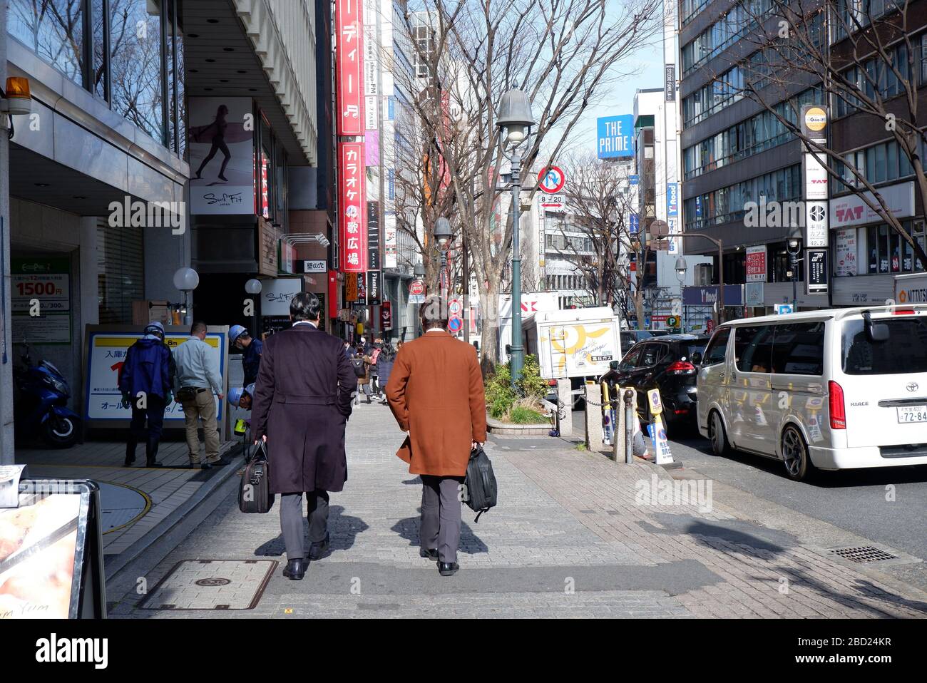 Tokio, Japan - Februar 2020 :zwei Salaryman zu Fuß in der Straße von Shibuya Stockfoto