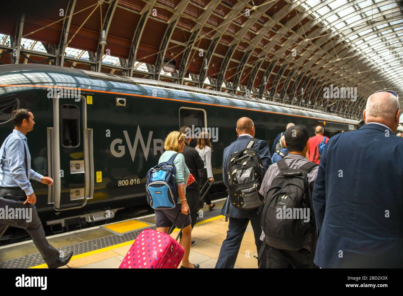 LONDON, ENGLAND - JULI 2018: Menschen, die auf einem Bahnsteig am Bahnhof London Paddington spazieren, um nach Bekanntwerden der Bahnsteignummer einen Zug zu nehmen. Stockfoto
