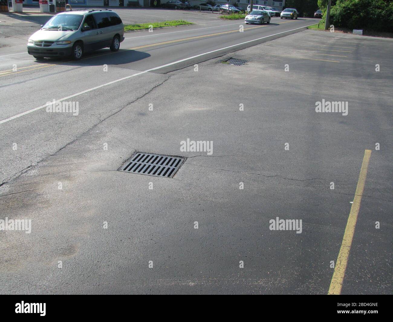 Der Abfluss aus diesem sealcoierten Lot fließt in den Sturmabfluss, wo er zu Bächen und Seen transportiert wird. Der Abfluss aus kohleäersealcoiertem Straßenbelag enthält extrem hohe Konzentrationen polyzyklischer aromatischer Kohlenwasserstoffe (PAHs) und ist giftig für Wasserlebewesen Stockfoto