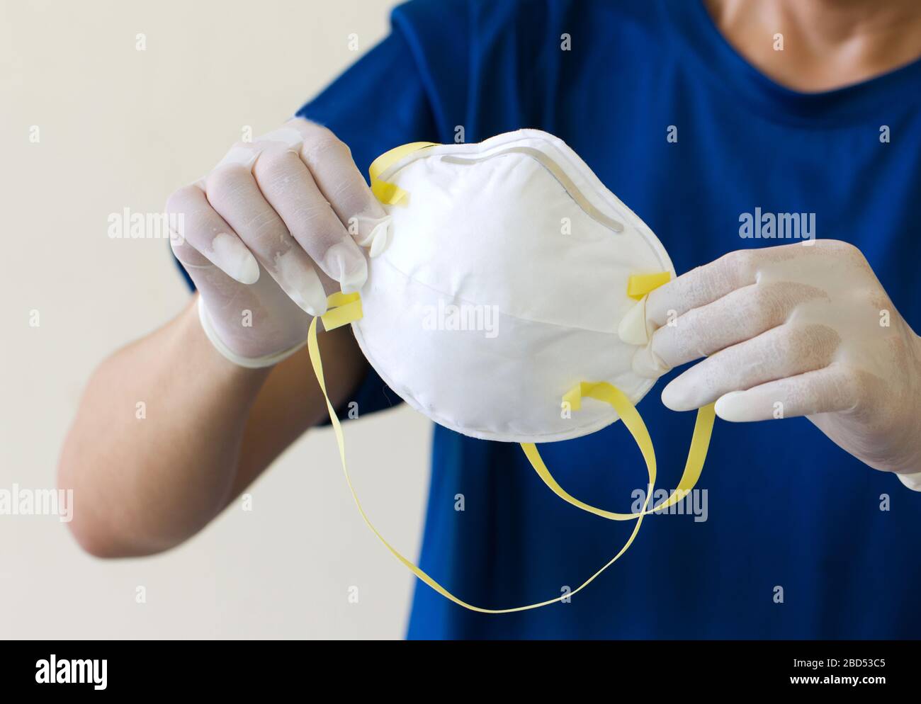 Asiatische Männer tragen medizinische Handschuhe und halten medizinische Masken N95. Um Kampagne zu tragen, um den Corona Virus zu verhindern, der sich auf der ganzen Welt verbreitet. Stockfoto