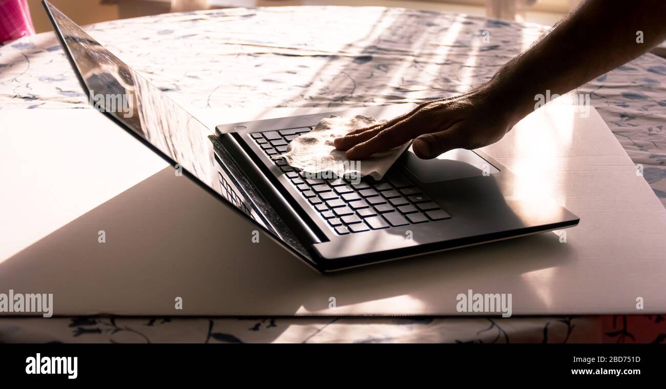 Tragbare Tastatur für die manuelle Reinigung von Männern in asien mit antibakteriellen Wischtüchern während der Quarantäne, Schweden Stockfoto