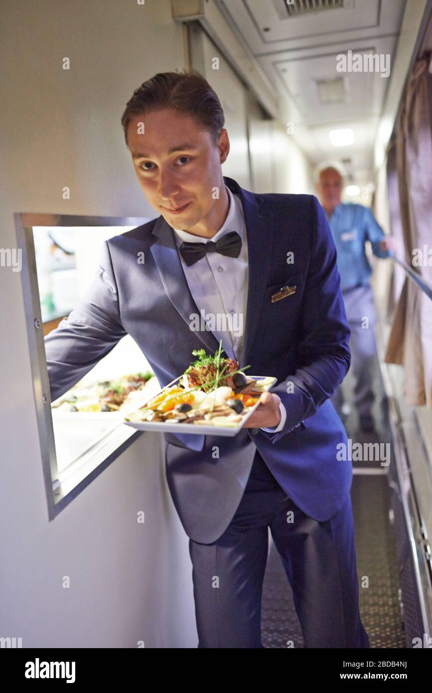 Kellner bei der Arbeit im Restaurantwagen des Zuges; Lebensmitteldienst, Speisewagen, Luxuszug Stockfoto