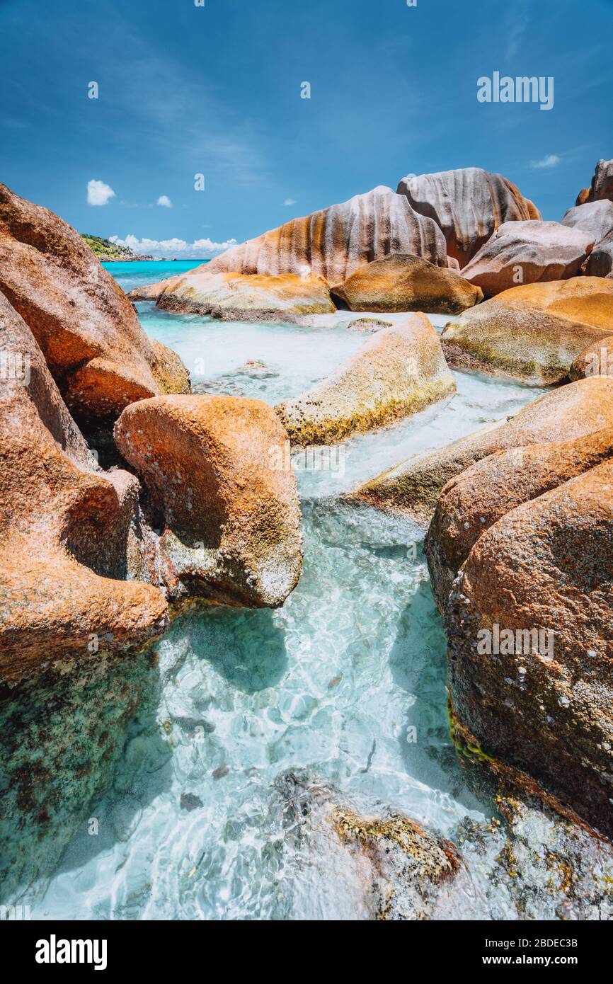 Bizarre Felsen in blauem Meerwasser am Strand Anse Cocos, Insel La Digue, Seychellen Stockfoto