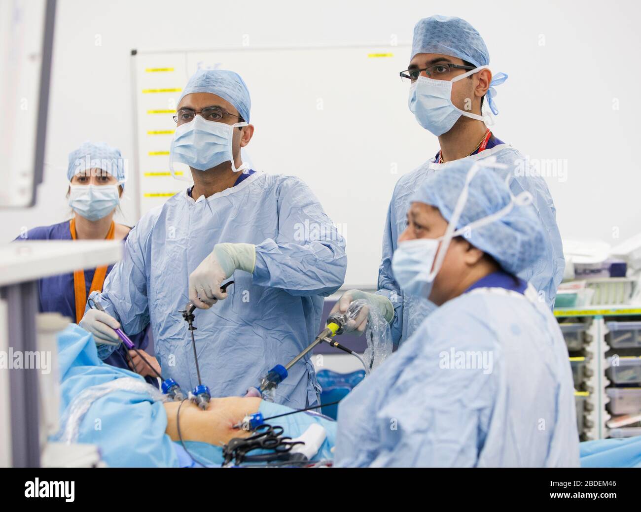 Chirurgen und Krankenschwestern führen eine laparaskopische Magenoperation in einem NHS-Krankenhaus durch. Die NHS steht wegen der Unterfinanzierung durch die Regierung unter Druck. Stockfoto