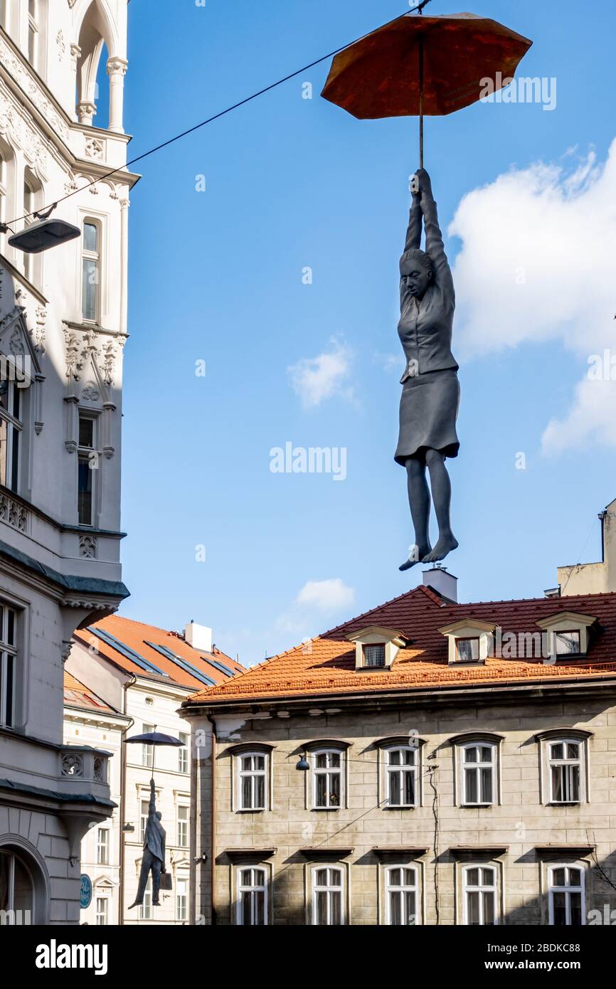 Hängende Frau und Mann mit Schirmskulptur namens leichte Unsicherheit von Michal Trpak in Nove Mesto, Prag, Tschechische Republik Stockfoto