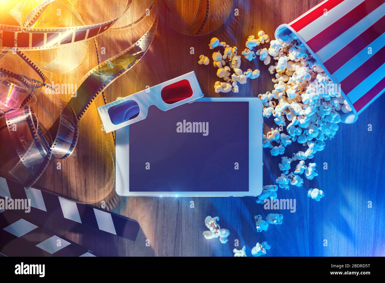 Digital Touch-Screen-Tablette mit Popcorn, 3D-Brille und Filmstreifen; Film Online-Streaming-Kino und Entertainment-Konzept Stockfoto