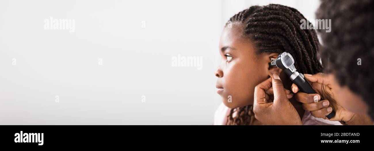 Kinderarzt Überprüft Ohrinfektion Von African American Girl Stockfoto
