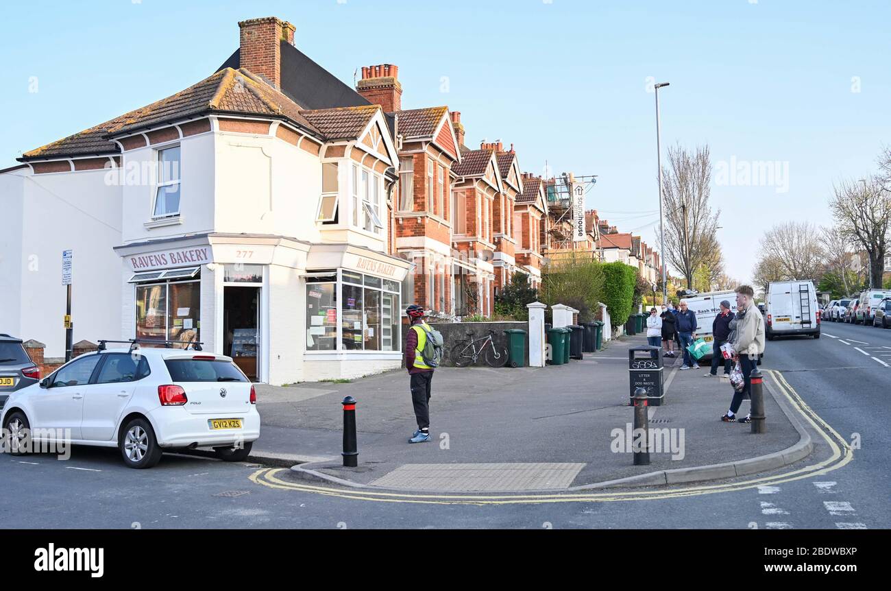 Brighton UK 10. April 2020 - die Käufer stehen am Karfreitagmorgen früh in der Ravens Bakery in Brighton an, wo sie für ihre heißen Brötchen berühmt sind. Die Regierung hat der Öffentlichkeit gesagt, während des Coronavirus COVID-19 Pandemiekrise am Osterwochenende nicht zu gehen. Quelle: Simon Dack / Alamy Live News Stockfoto