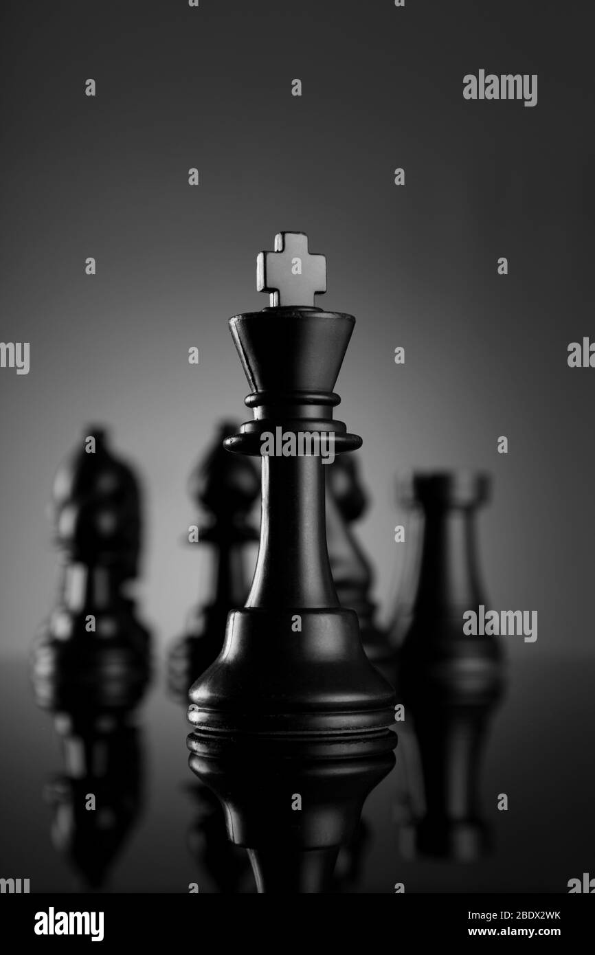 Führung Schach König mit Figuren auf dunklem Hintergrund Stockfoto