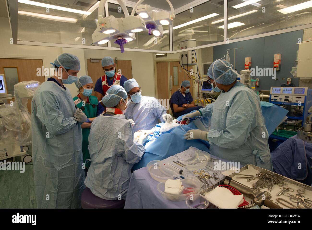 NHS Chirurgen und Krankenschwestern führen eine Operation in einem NHS Krankenhaus durch.die Coronavirus-Pandemie hat Druck auf das NHS mit personeller und personeller Ausstattung ausgeübt. Stockfoto