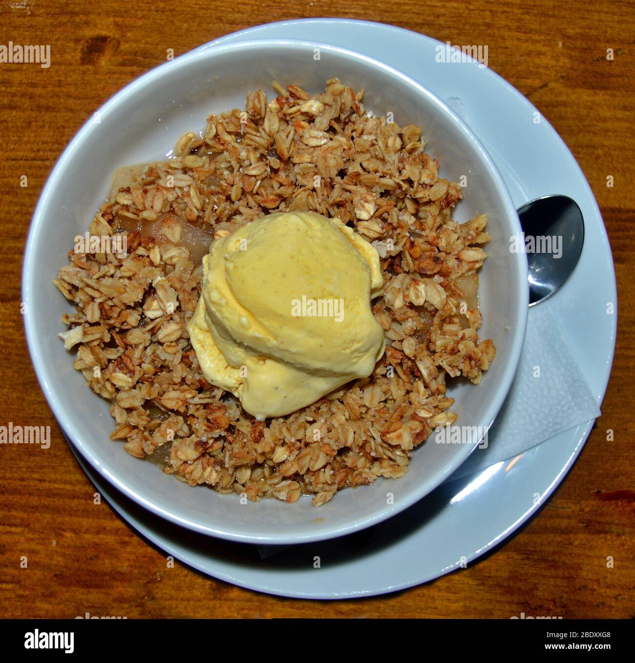 Draufsicht der weißen Schüssel auf dem Tisch mit leckeren Hafer vom Koch mit Vanille-Eis auf der Oberseite vorbereitet gefüllt, gread Dessert Ideen, die gesund und delici sind Stockfoto