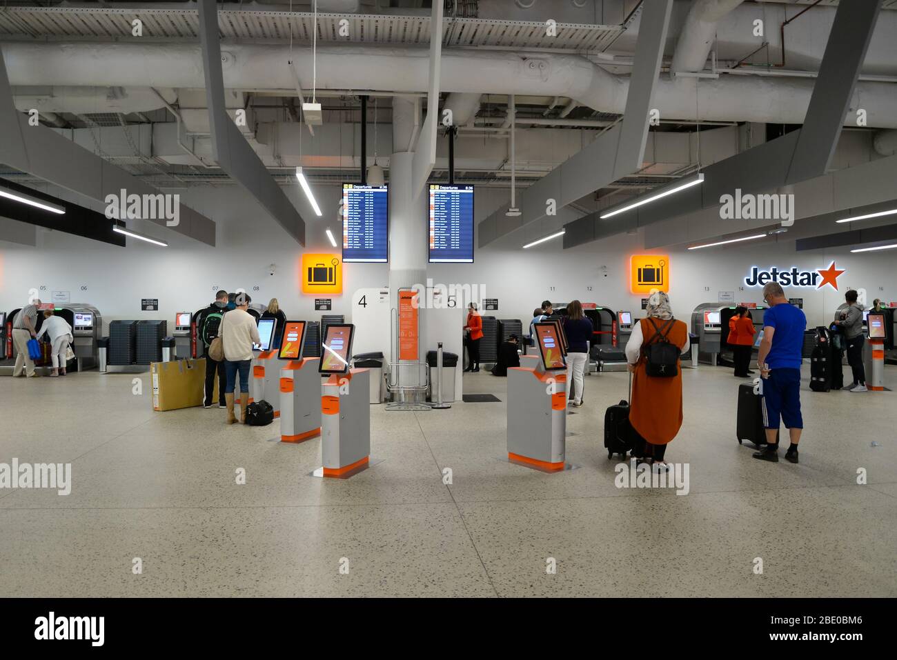 Check-in-Bereich der Billigfluglinie Jetstar am Inlandsterminal Tullmarine. Passagiere, die Automaten für den automatischen Check-in (Tote) und Gepäckabgabeautomaten nutzen. Stockfoto