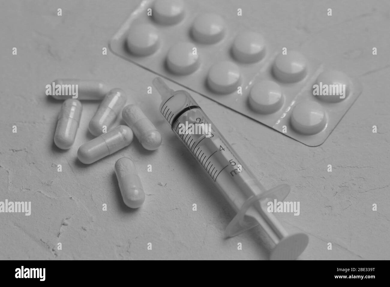 Spritze und Tabletten auf weißem Hintergrund, Konzept für Medizin, Gesundheit und Kosten Stockfoto