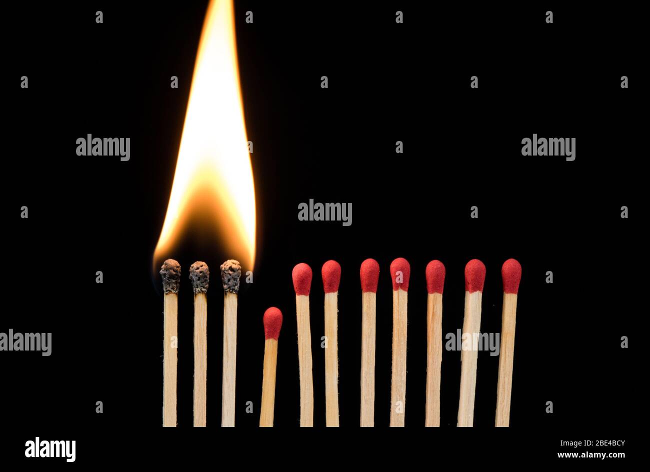 Streichhölzer brennen vor dem Hintergrund, ein Stück herunterfallen verhindert das Feuer an der Ausbreitung Stockfoto