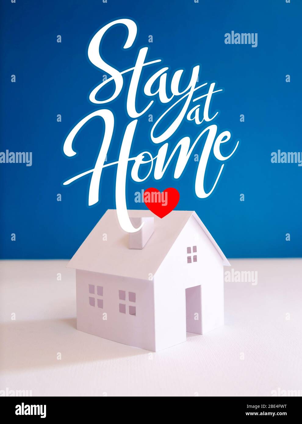 White Paper House mit Text "Stay at Home", um das Infektionsrisiko und die Verbreitung des Virus während der Coronavirus-Pandemie zu reduzieren Stockfoto