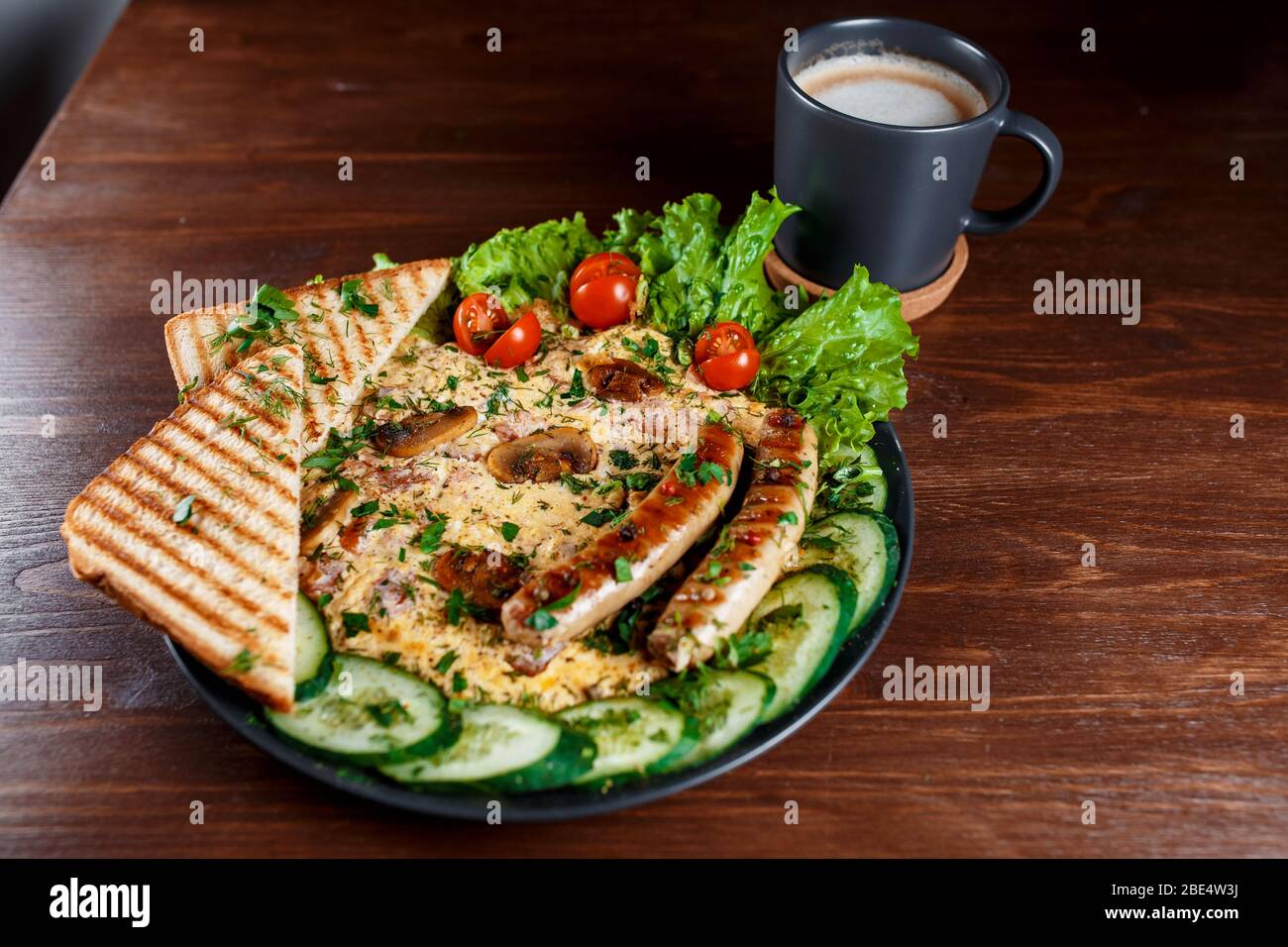 Sandwiches mit Würstchen, Dill und einem Zweig Basilikum auf einem weißen Teller auf einem Holztisch erröten. Die Idee des schnellen Kochens. Nahaufnahme. Stockfoto