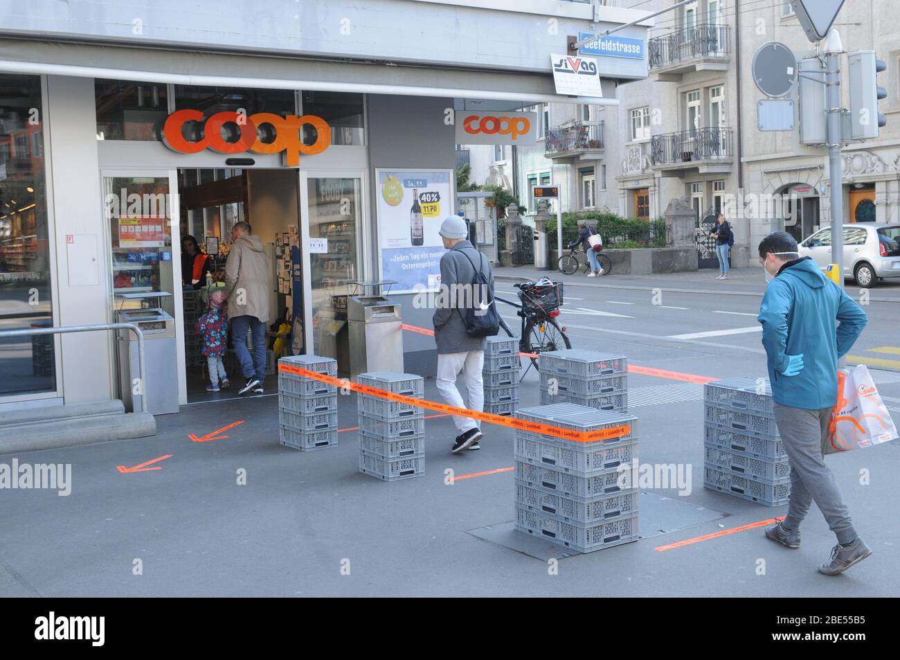 Zürich/Schweiz: Shopping in Zeiten von Covid19 Coronavirus. Draußen mit zwei Metern Abstand und beschränkter Zugangszahl von Menschen zu stehen, erlaubte ich Stockfoto