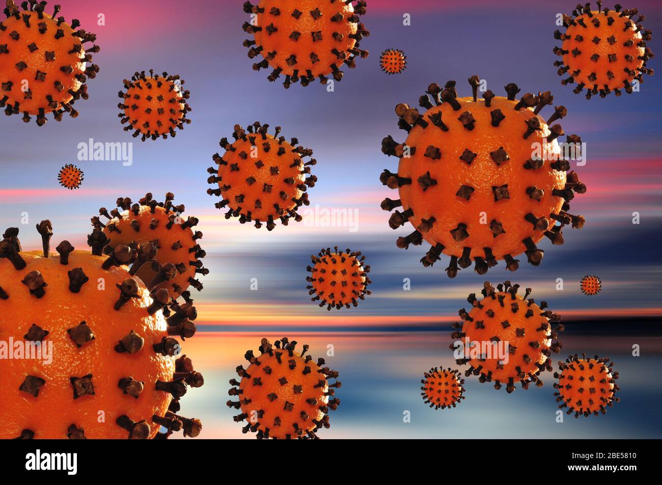 Komponieren mit einem Modell eines Corona-Virus, bestehend aus einer Orange mit Nelken gespickt Stockfoto