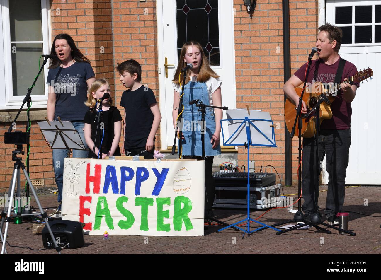 Glasgow, Schottland, Großbritannien, 12., April, 2020. Lockdown in Glasgow. Eine Familie aus dem Süden veranstaltet an diesem sonnigen Ostersonntag eine musikalische Darbietung im Freien zur Freude der Nachbarn während der aktuellen Sperrung aufgrund der Pandemie von Covid19. Stockfoto