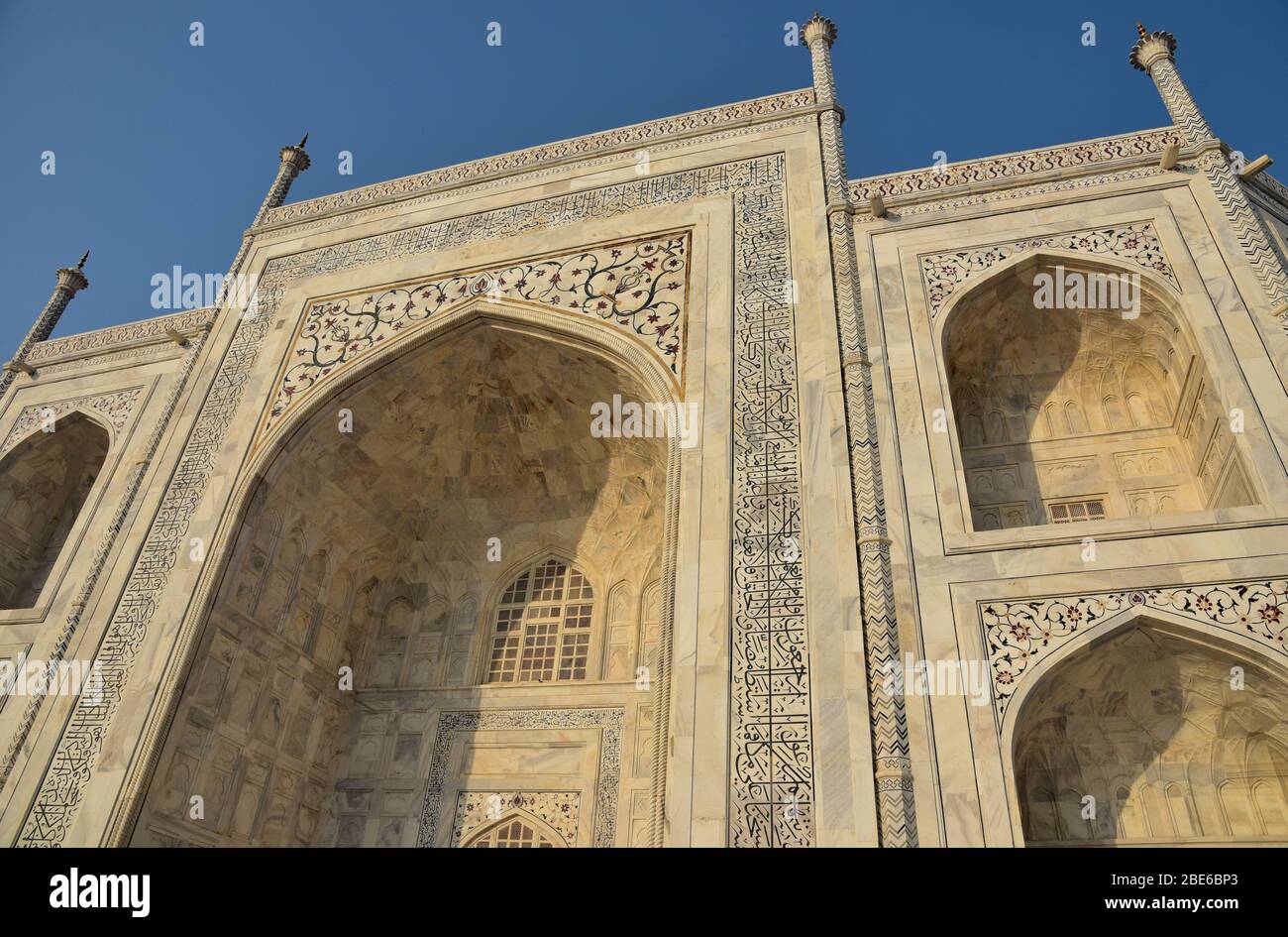 Kalligraphie von arabischem Ayaat, reflektierende und dekorative Fliesen, eingelassene Bögen und elfenbeinweißer Marmor bilden die Schönheit des Taj Mahal, Agra, Indien. Stockfoto