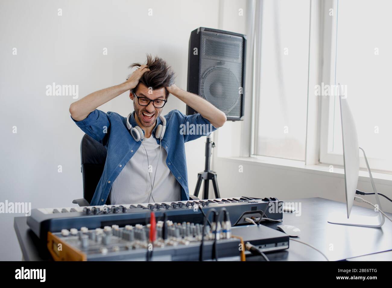 Stress am Arbeitsplatz. Aggressives Verhalten männliche Musik Arrangeur Hände komponieren Song auf Midi-Klavier und Audio-Equipment in digitalen Tonstudio. Mann Stockfoto