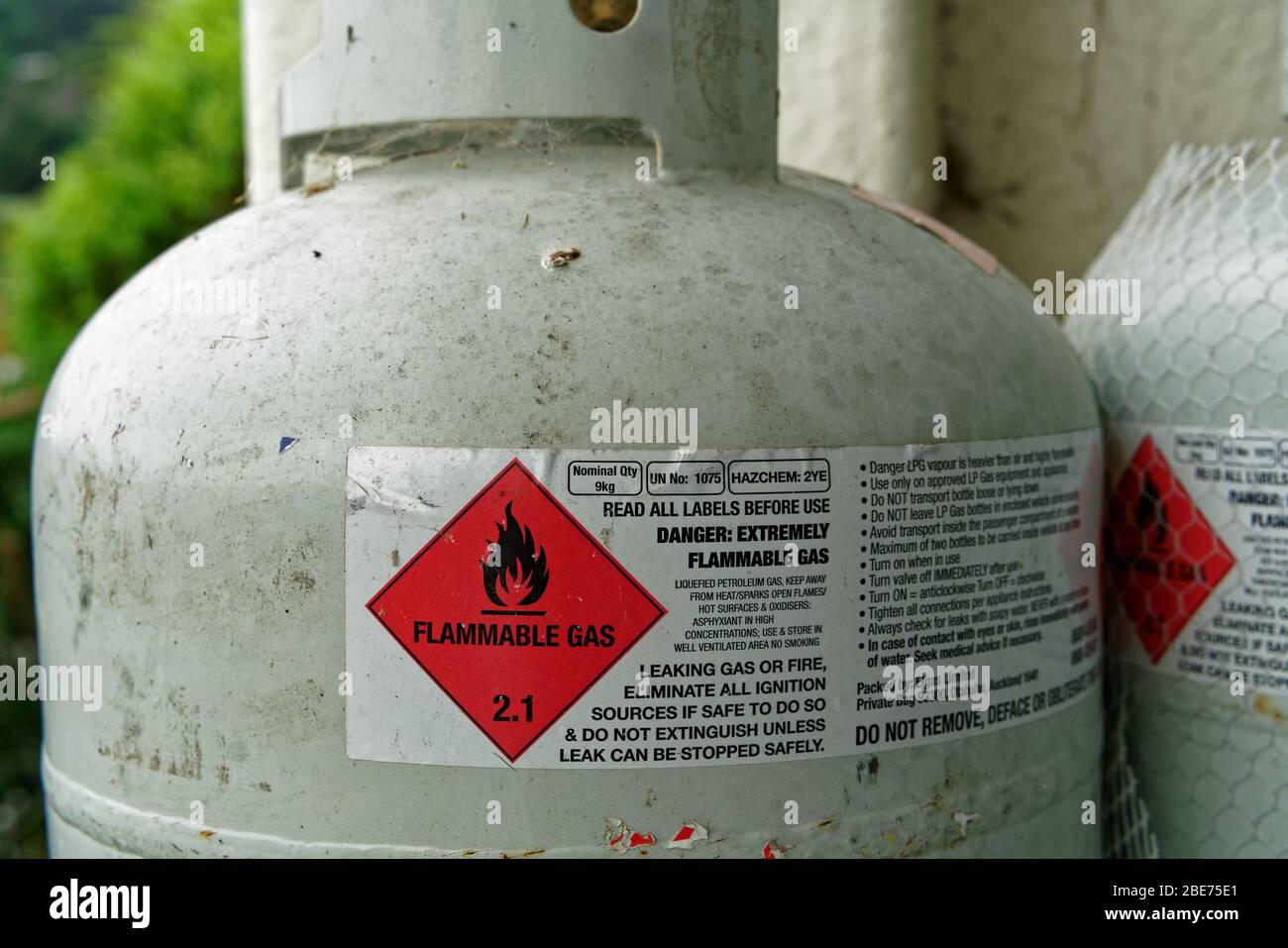 Illustratives Editorial: Warnschild an Treibgasflasche - 1. Februar 2020: Warnsymbol für brennbares Gas und Informationstafel an einer Treibgasflasche Stockfoto
