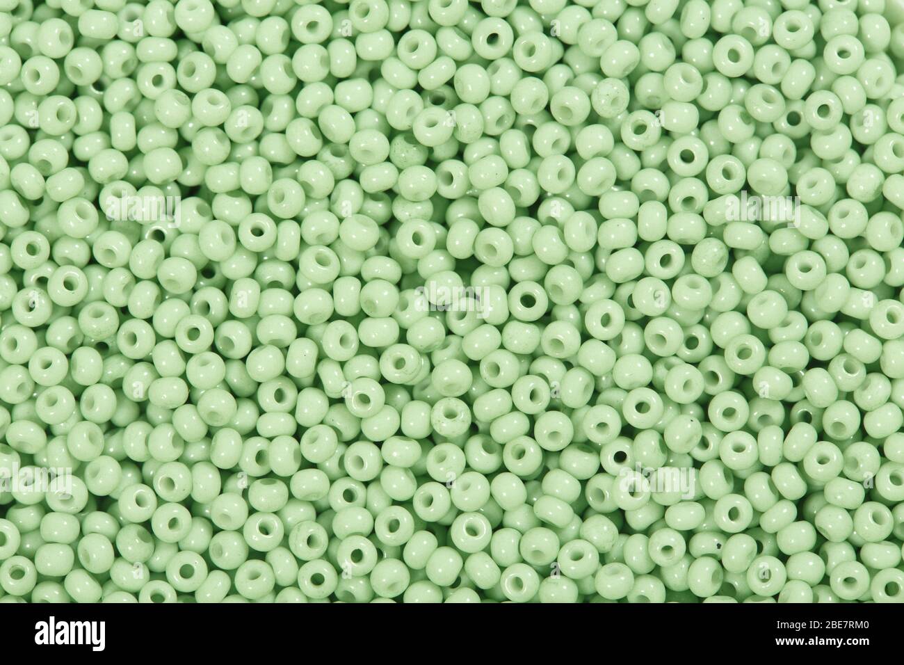 Blassgrüne Samenkörner in Texturform. Stockfoto
