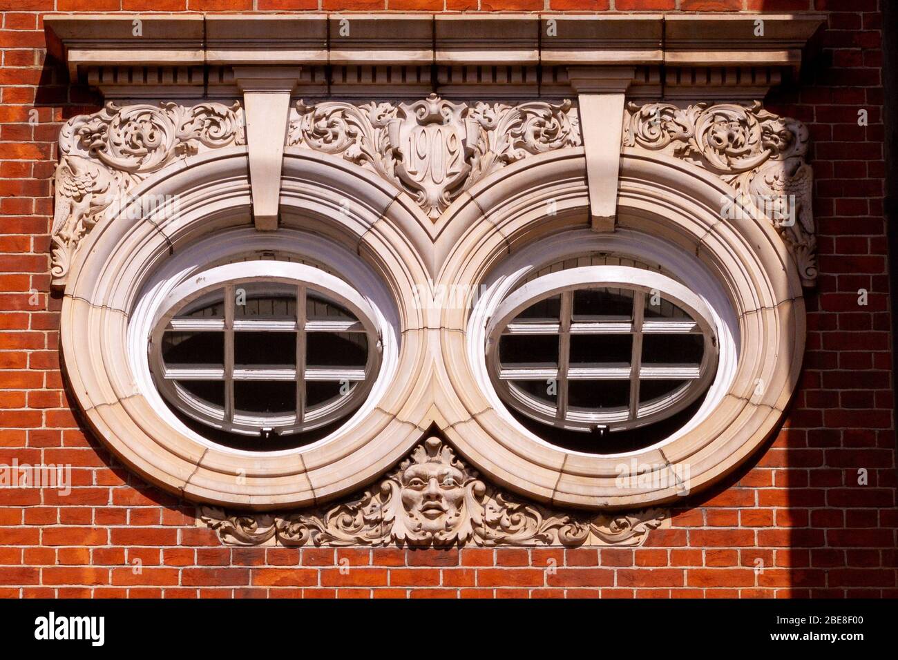 Wunderschöne runde Fenster, die in einem alten Gebäude aus dem Jahr 1902 in London renoviert wurden Stockfoto
