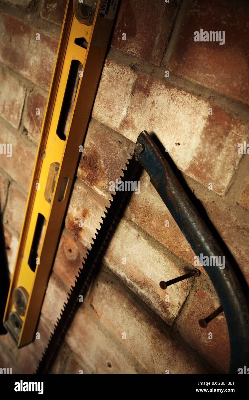 Wasserwaage und Bogensäge in der Werkstatt. Stockfoto