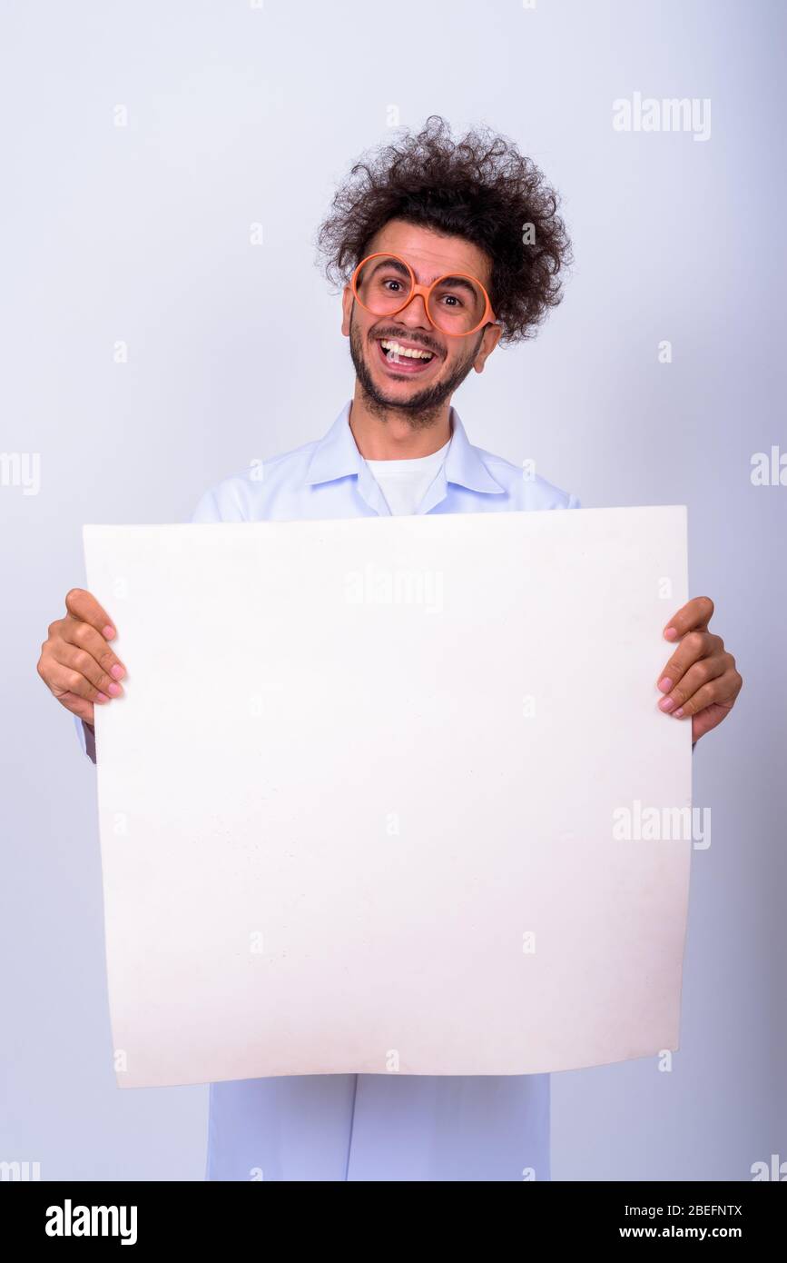 Portrait von lustigen türkischen Mann Arzt mit lockigen Haaren hält weiße Tafel Stockfoto