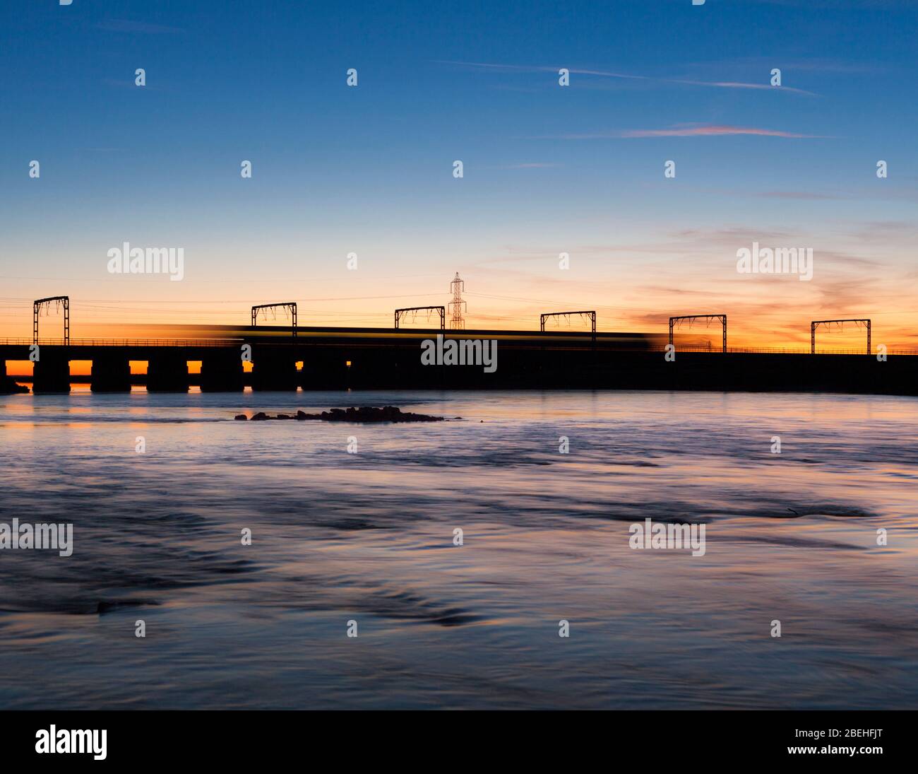 Virgin Trains / Avanti Westküste Überqueren des Flusses Esk Viadukt bei Mossband an der Westküste Hauptlinie mit Bewegungsunschärfe bei Sonnenuntergang Stockfoto