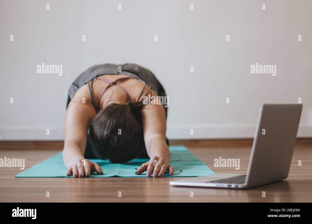 Frau, die online Yoga zu Hause macht Stockfoto