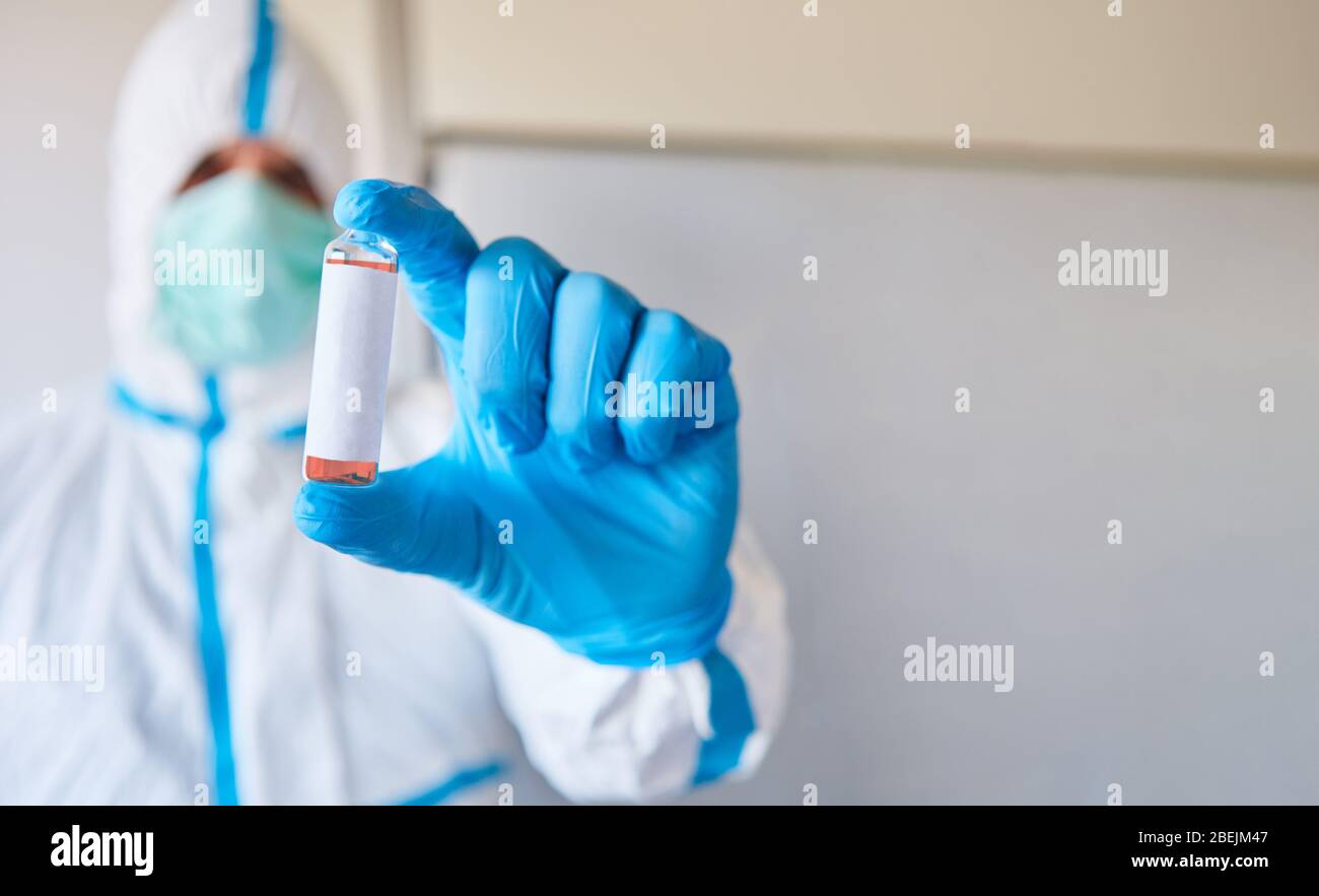Forscher im Labor mit Impfstoffampulle zur Analyse und als Test gegen Coronavirus und Covid-19 Stockfoto