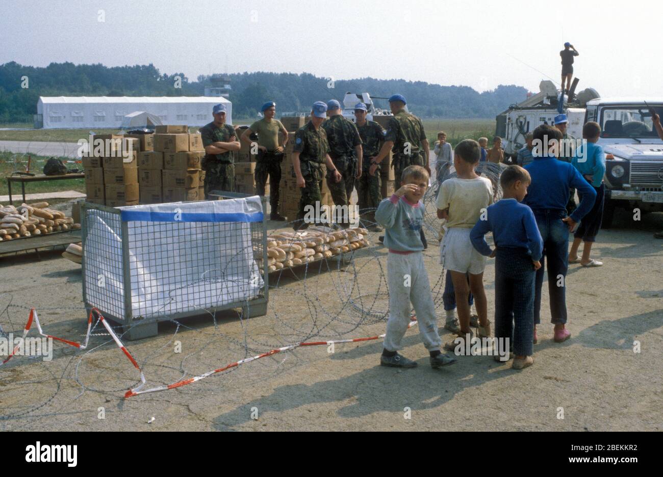 1995 Tuzla, Bosnien - Flugplatz Tuzla temporäres UN-Flüchtlingslager für bosnische Muslime, die vor dem Massaker von Srebrenica während des Bosnienkrieges fliehen, in dem Bild, dass von UN-Soldaten Brot geliefert wird Stockfoto