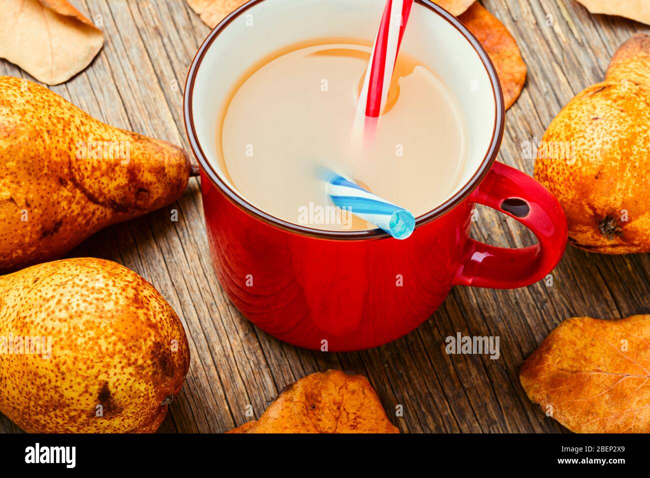 Tasse mit leckerem Birnensaft, Obstgetränk auf einem Holztisch im Landhausstil. Stockfoto