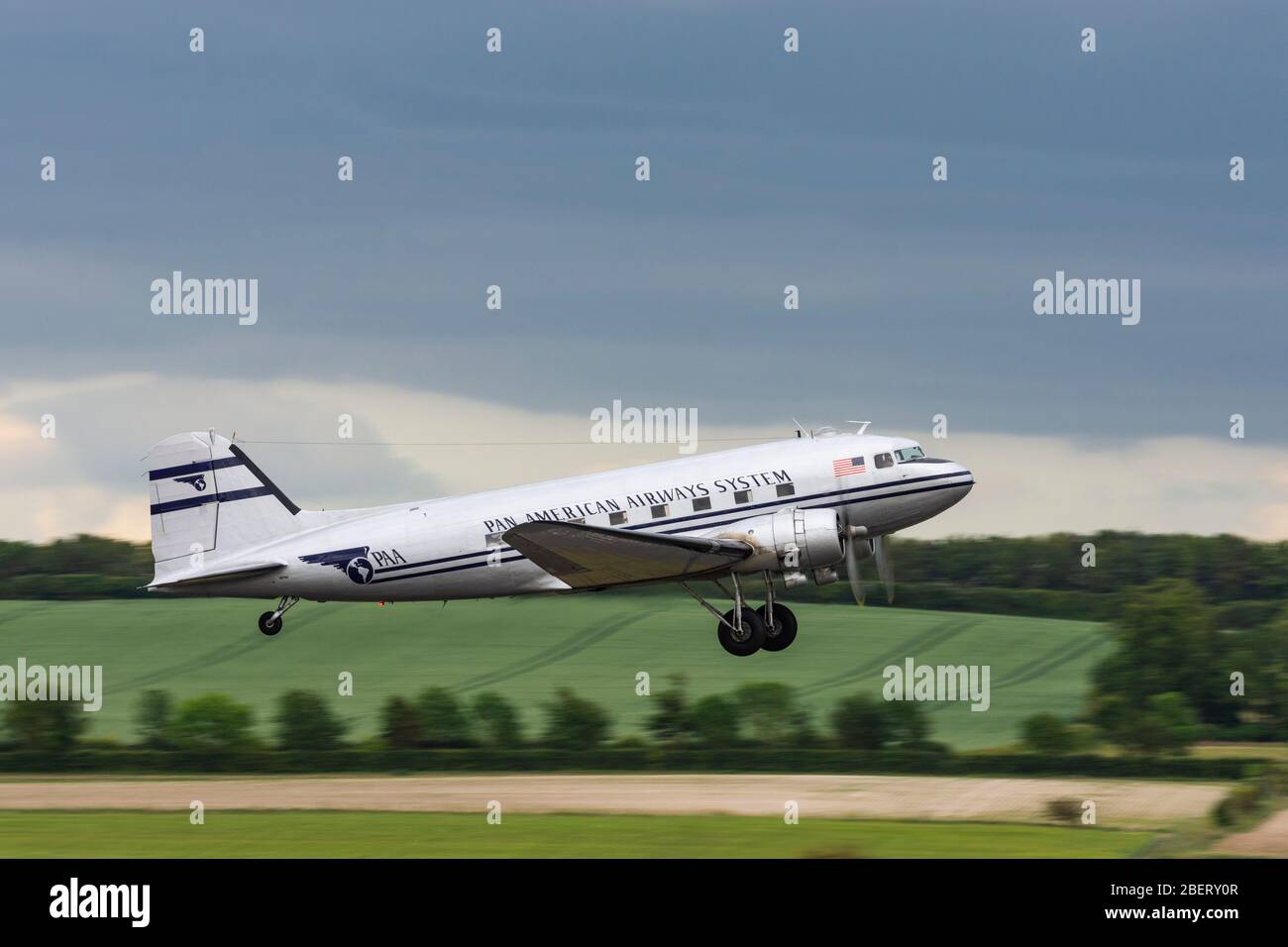 Seitenansicht eines Pan American Airways System Douglas C 47 Dakota, der während des D Day 75 Gedenkens von Duxford abfliegt Stockfoto