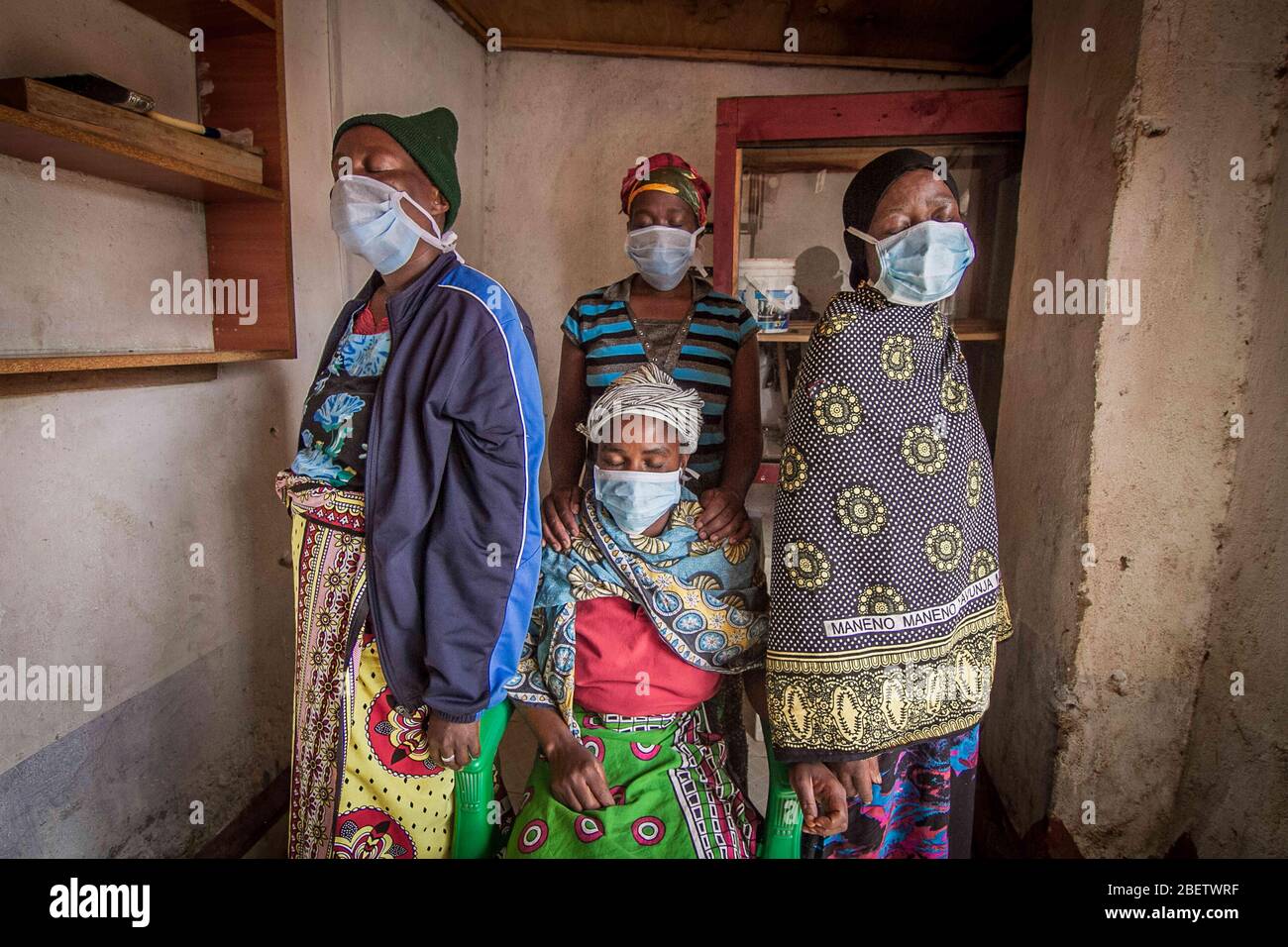 Nairobi, Kenia. April 2020. Frauen, die Gesichtsmasken tragen, um die Ausbreitung des Coronavirus zu verhindern, beten mit verschiedenen Richtungen, um die Ausbreitung des Corona Virus zu vermeiden.Trotz der Ausgangssperre, die durch die Corona Virus Pandemie verursacht wird, gehen die meisten Bewohner in den Slums von Kibera wie gewohnt weiter. Die meisten Einwohner würden ihr Geschäft ohne Gesichtsmasken und Handdesinfektionsmittel fortsetzen, eine Situation, die zur einfachen und schnellen Ausbreitung des Corona Virus von einer Person zur anderen führen könnte. Kredit: Donwilson Odhiambo/SOPA Images/ZUMA Wire/Alamy Live News Stockfoto